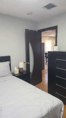 a bedroom with a bed and a mirror
