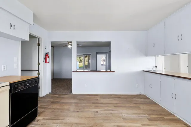 a view of a kitchen with an empty space and a window