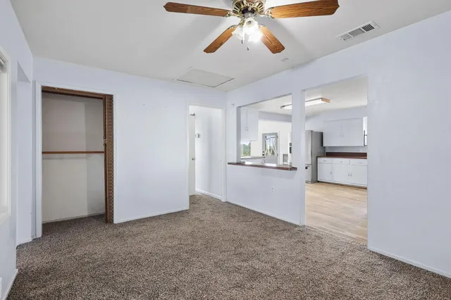 a view of a kitchen with a sink and a refrigerator
