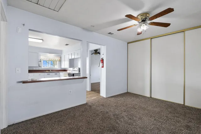 a view of kitchen with stainless steel appliances granite countertop cabinets and a sink
