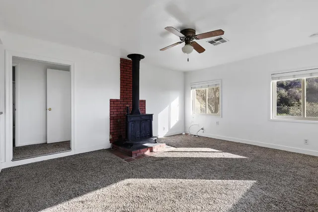 a view of empty room with ceiling fan