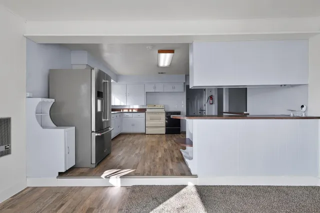 a kitchen with a refrigerator and a sink
