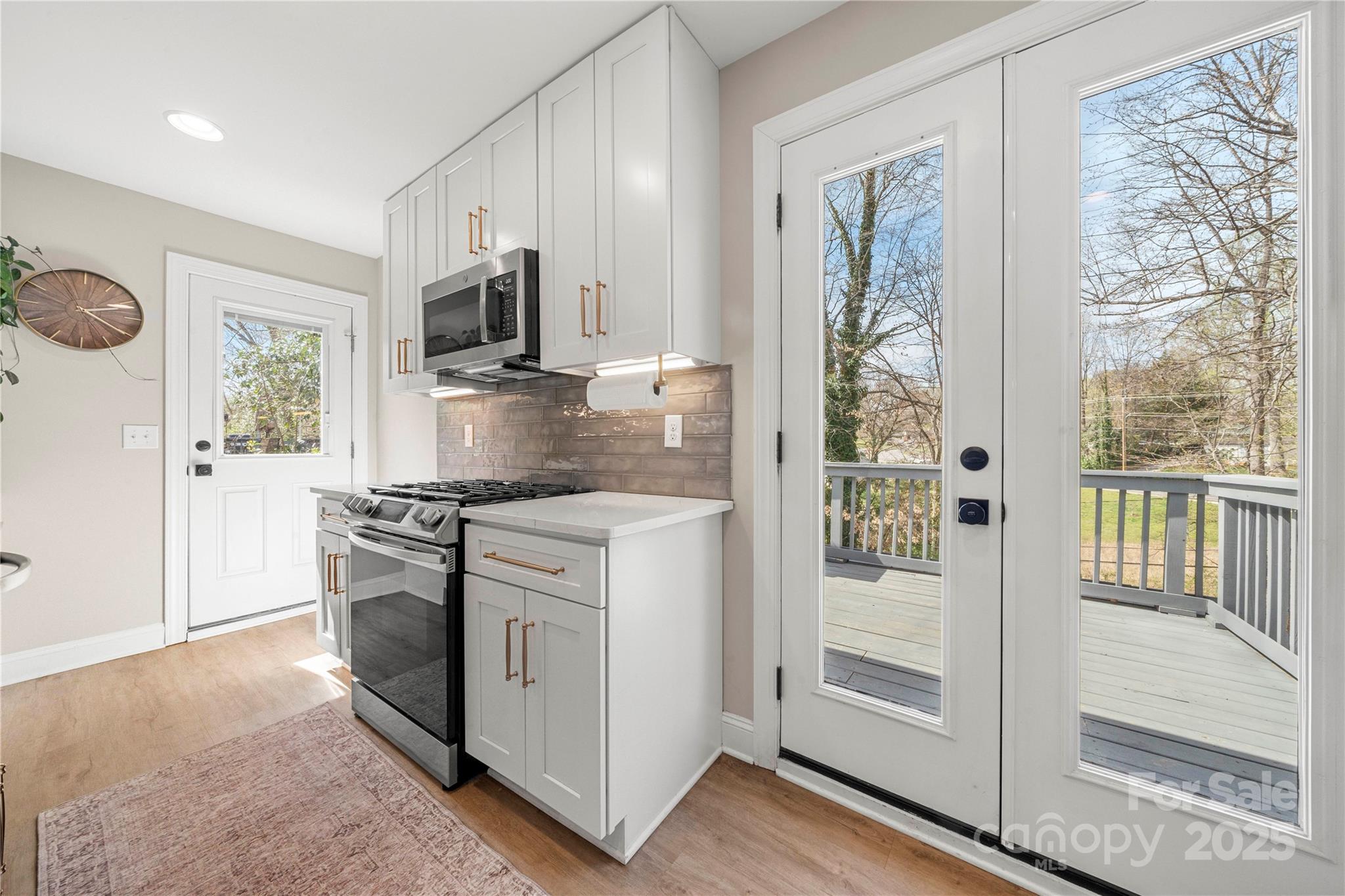 4820 Valley Stream Road Charlotte, NC 28209 - Photo 12 of 37 a kitchen with stainless steel appliances granite countertop a stove a microwave and a refrigerator