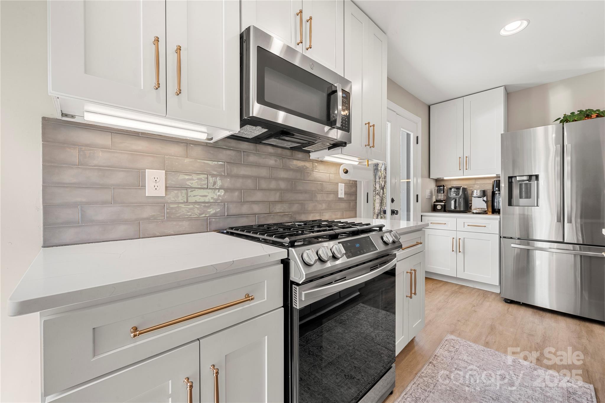 4820 Valley Stream Road Charlotte, NC 28209 - Photo 15 of 37 a kitchen with a stove and a microwave