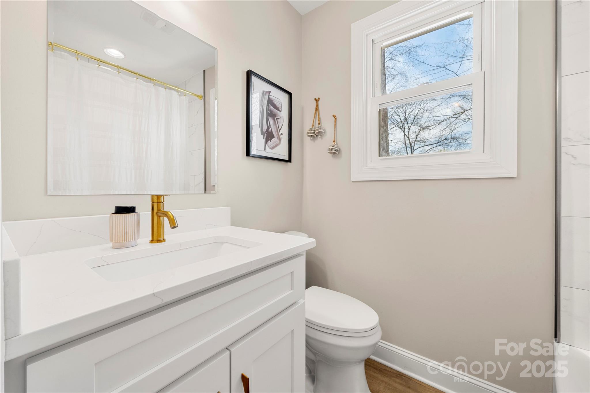 4820 Valley Stream Road Charlotte, NC 28209 - Photo 17 of 37 a bathroom with a sink a toilet and mirror