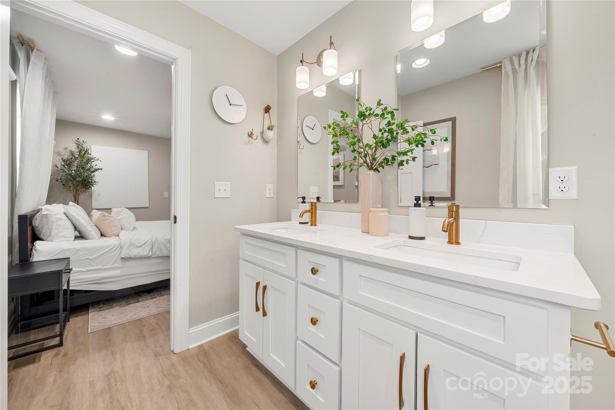 4820 Valley Stream Road Charlotte, NC 28209 - Photo 22 of 37 a spacious bathroom with double vanity a mirror and a lamp