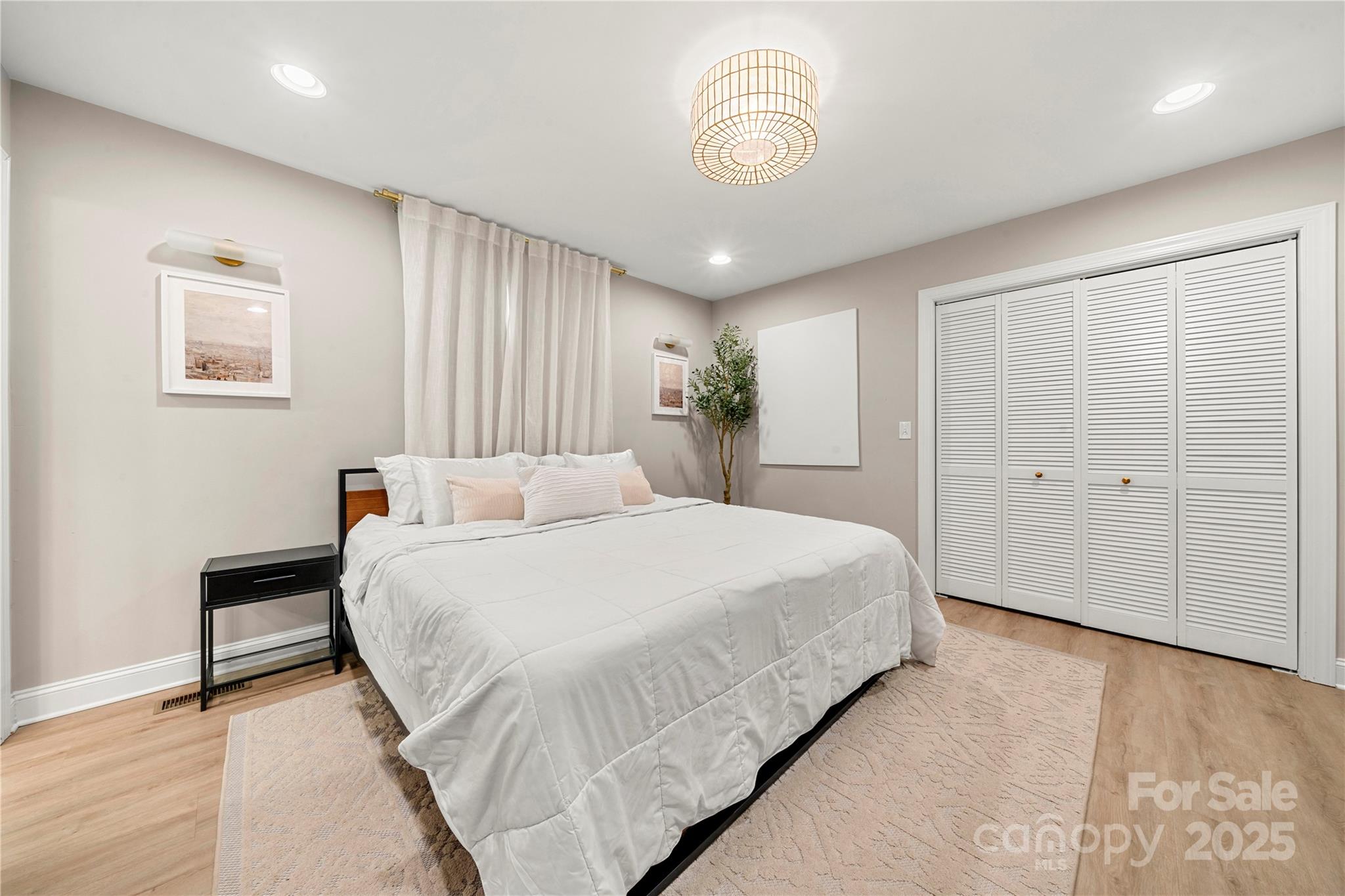 4820 Valley Stream Road Charlotte, NC 28209 - Photo 25 of 37 a bedroom with a bed and a chandelier