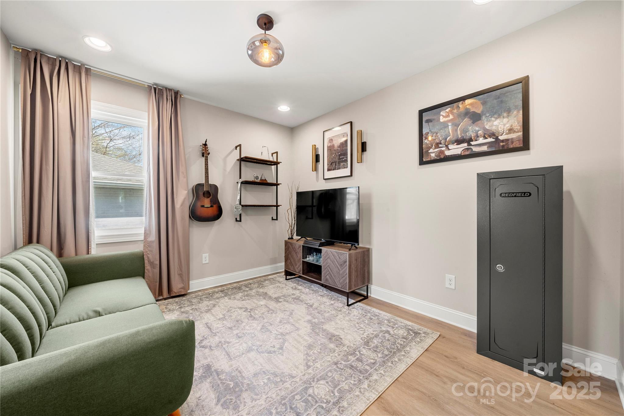 4820 Valley Stream Road Charlotte, NC 28209 - Photo 26 of 37 a living room with furniture and a flat screen tv