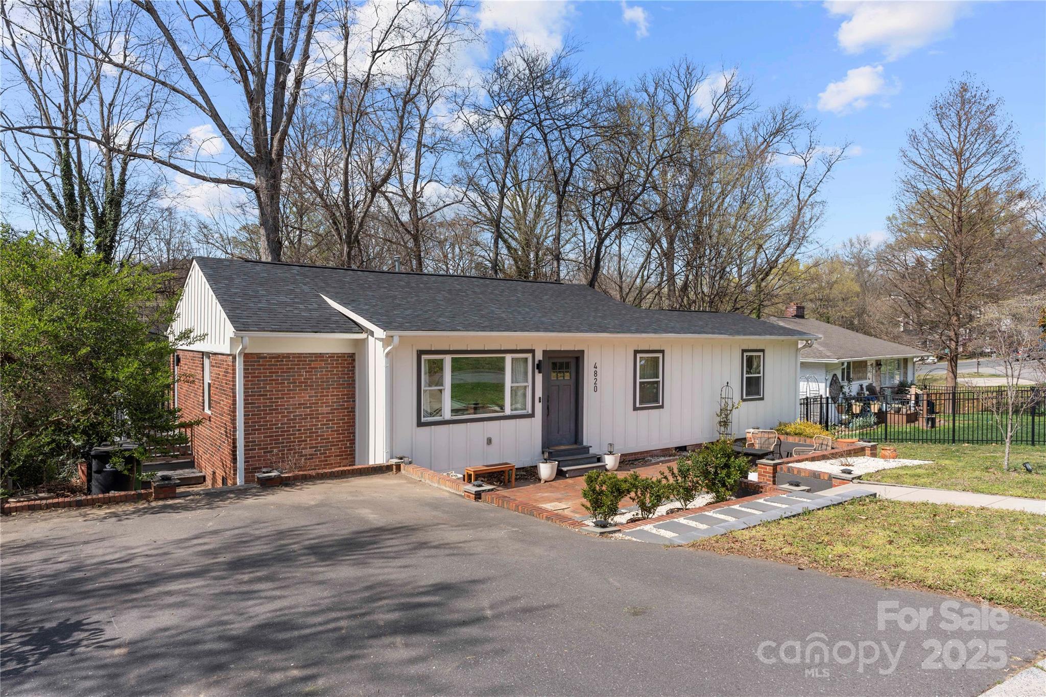 4820 Valley Stream Road Charlotte, NC 28209 - Photo 3 of 37 a front view of house with yard and trees around