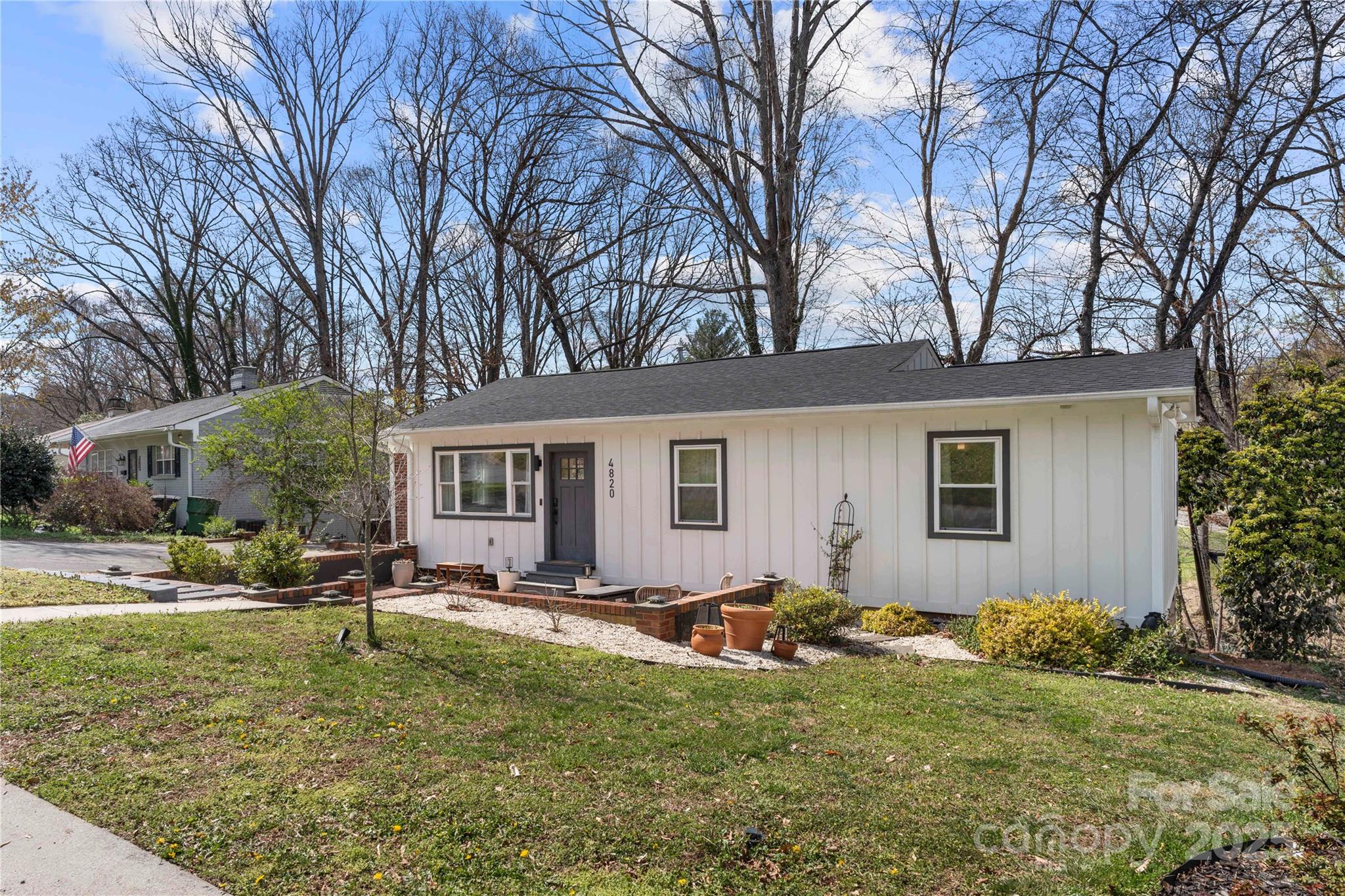 4820 Valley Stream Road Charlotte, NC 28209 - Photo 37 of 37 a backyard of a house with garden and outdoor seating