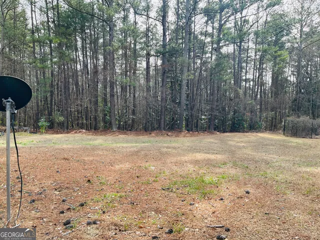a front view of a house with a tree