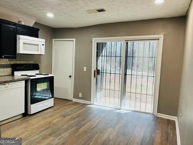 a view of hallway with wooden floor