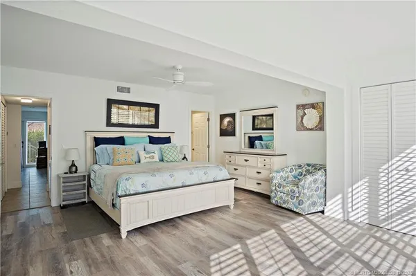 a bedroom with a bed and a large window