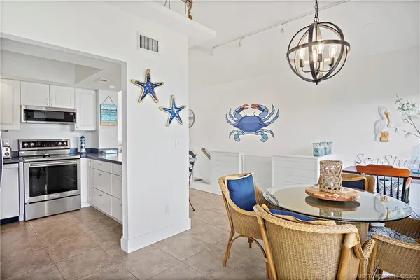 a view of a dining room with furniture and a chandelier