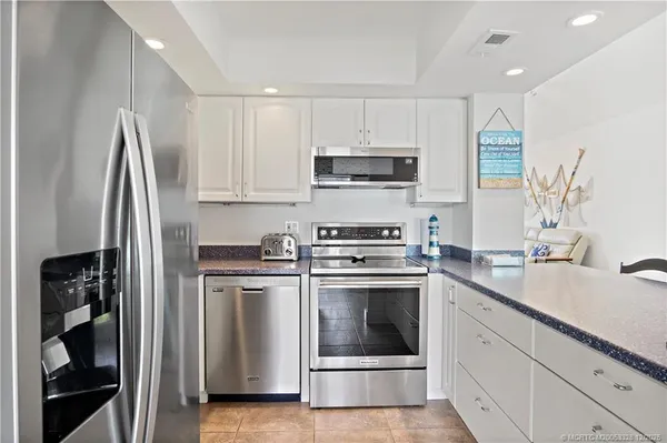 a kitchen with stainless steel appliances a stove a sink and a refrigerator
