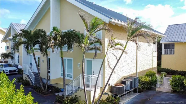 a view of a house with a palm tree