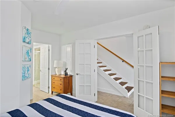 a bedroom with a bed and a painting on the wall