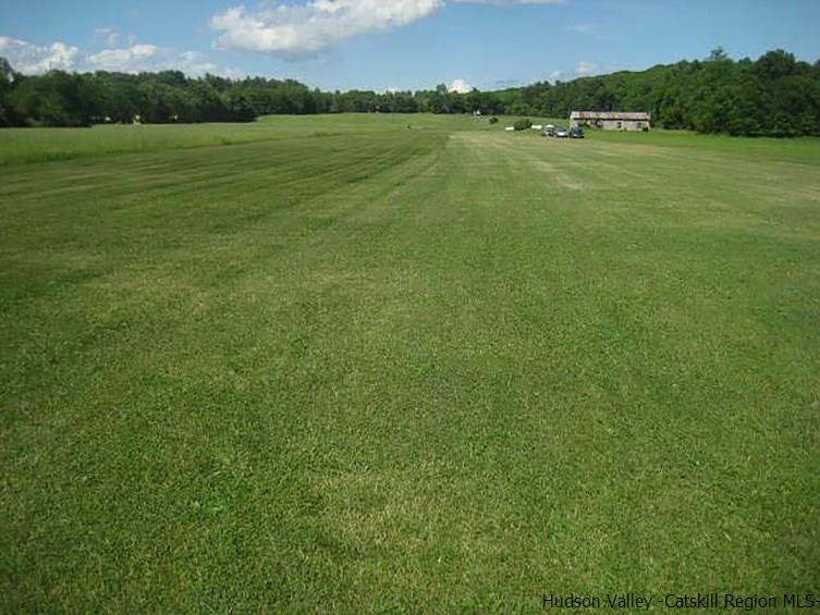 11 Airport Road, Unit 4938 ROUTE 209 Accord, NY 12404 - Photo 1 of 10 a view of a green field with an ocean view