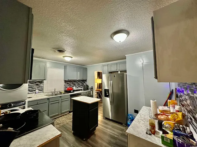 a kitchen with a refrigerator and a sink