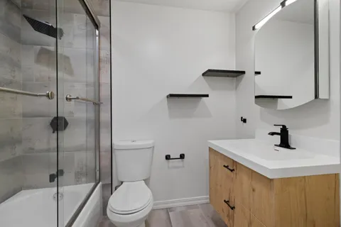 a bathroom with a sink toilet and shower