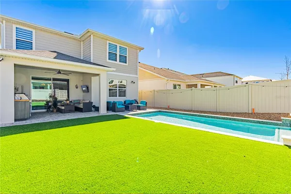 a view of a house with a backyard