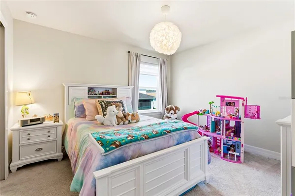 a bedroom with a bed dresser and a window