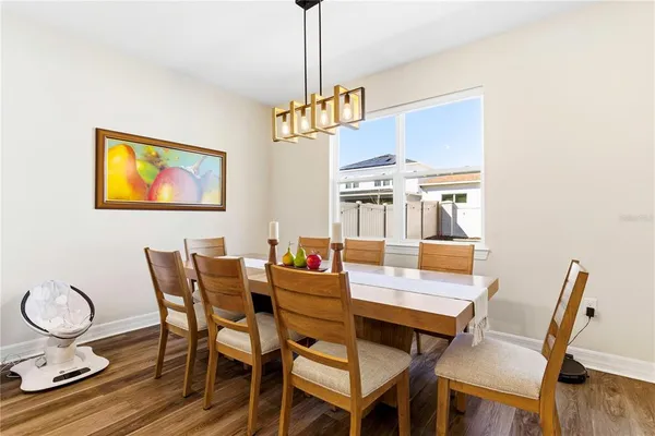 a dining room with furniture and wooden floor