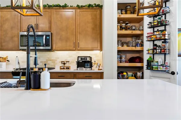 a kitchen with stainless steel appliances granite countertop a refrigerator and a sink