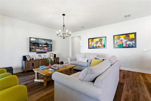 a living room with furniture and painting on the wall