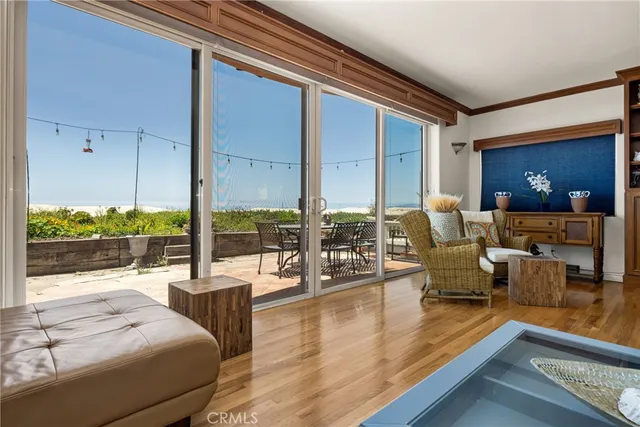 a kitchen with stainless steel appliances granite countertop a stove and a view of living room