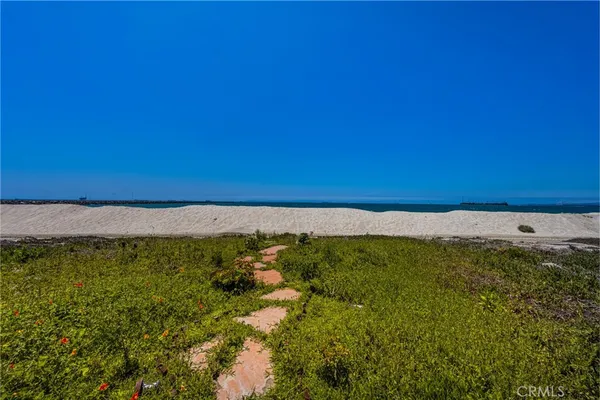 a view of a kitchen with stainless steel appliances kitchen island granite countertop a refrigerator and a stove top oven