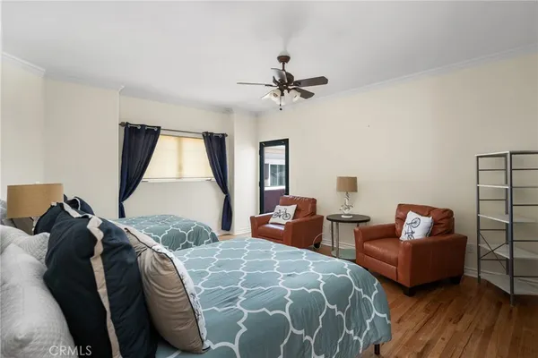 a large bedroom with a bed and glass window
