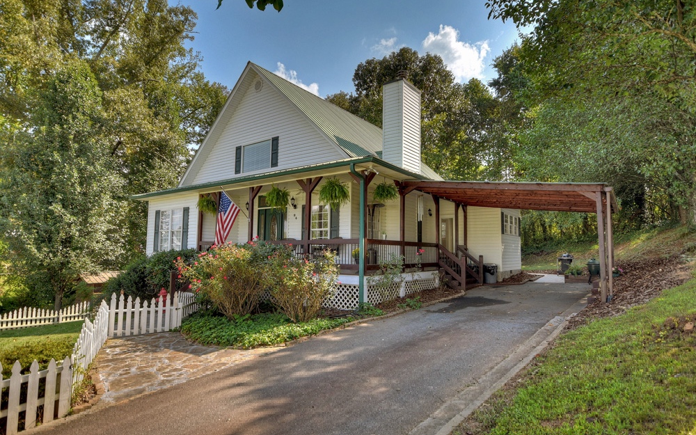 a view of a house with a yard and wooden fence