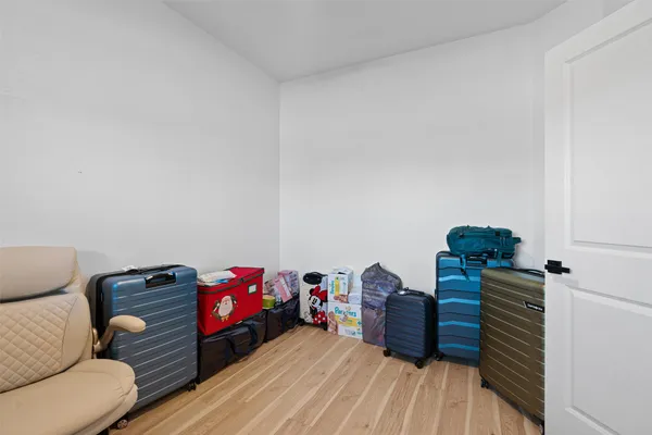a bedroom with furniture and wooden floor