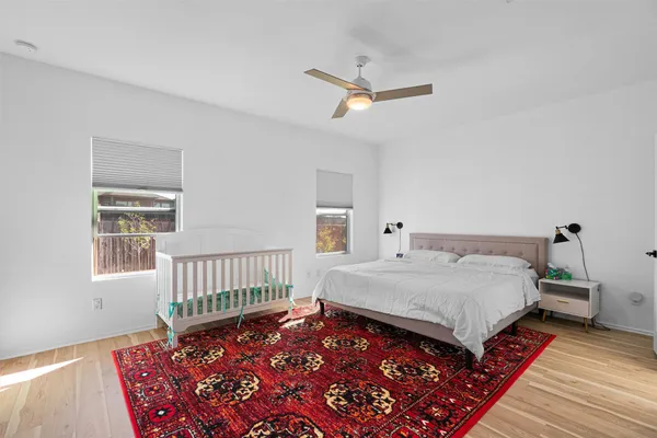 a bed sitting in a bedroom next to a window