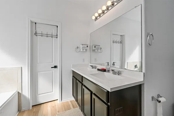a bathroom with a sink vanity and a mirror