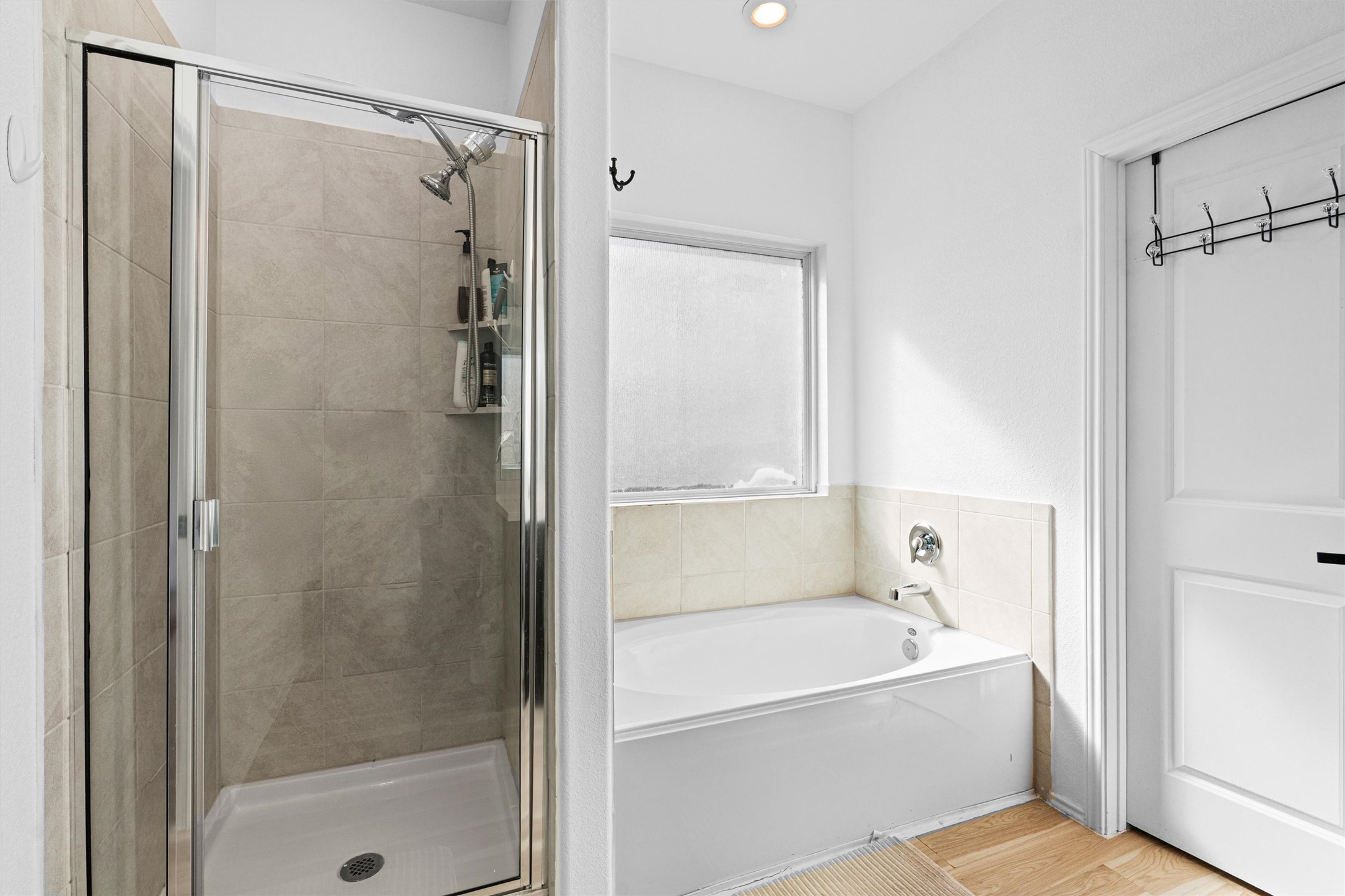 327 Andesite Trail Buda, TX 78610 - Photo 19 of 40 a bathroom with a bathtub and a shower
