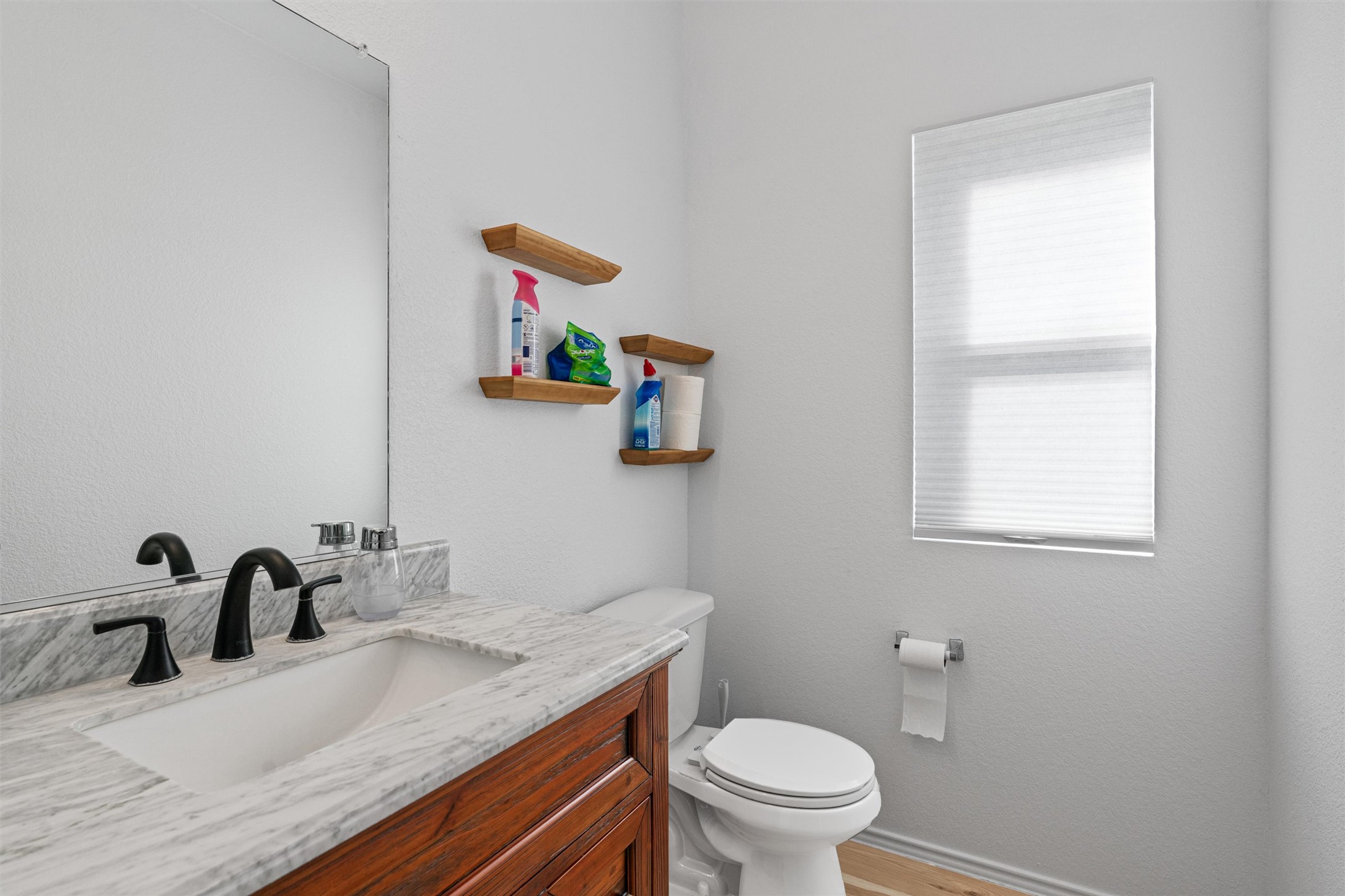 327 Andesite Trail Buda, TX 78610 - Photo 22 of 40 a bathroom with a granite countertop sink a toilet and a mirror