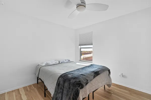 a bedroom with a bed and a window