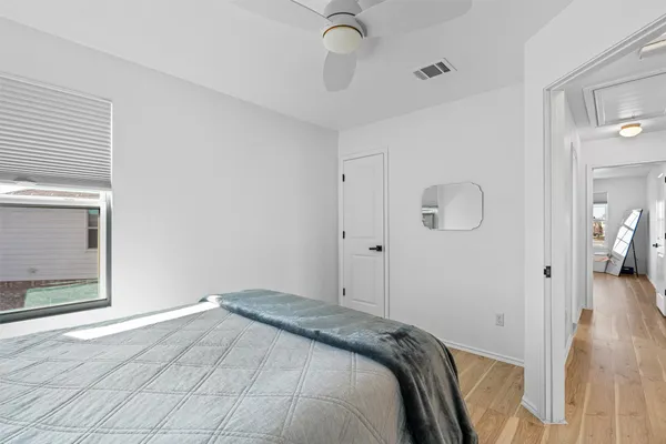 a bedroom with a bed and wooden floor