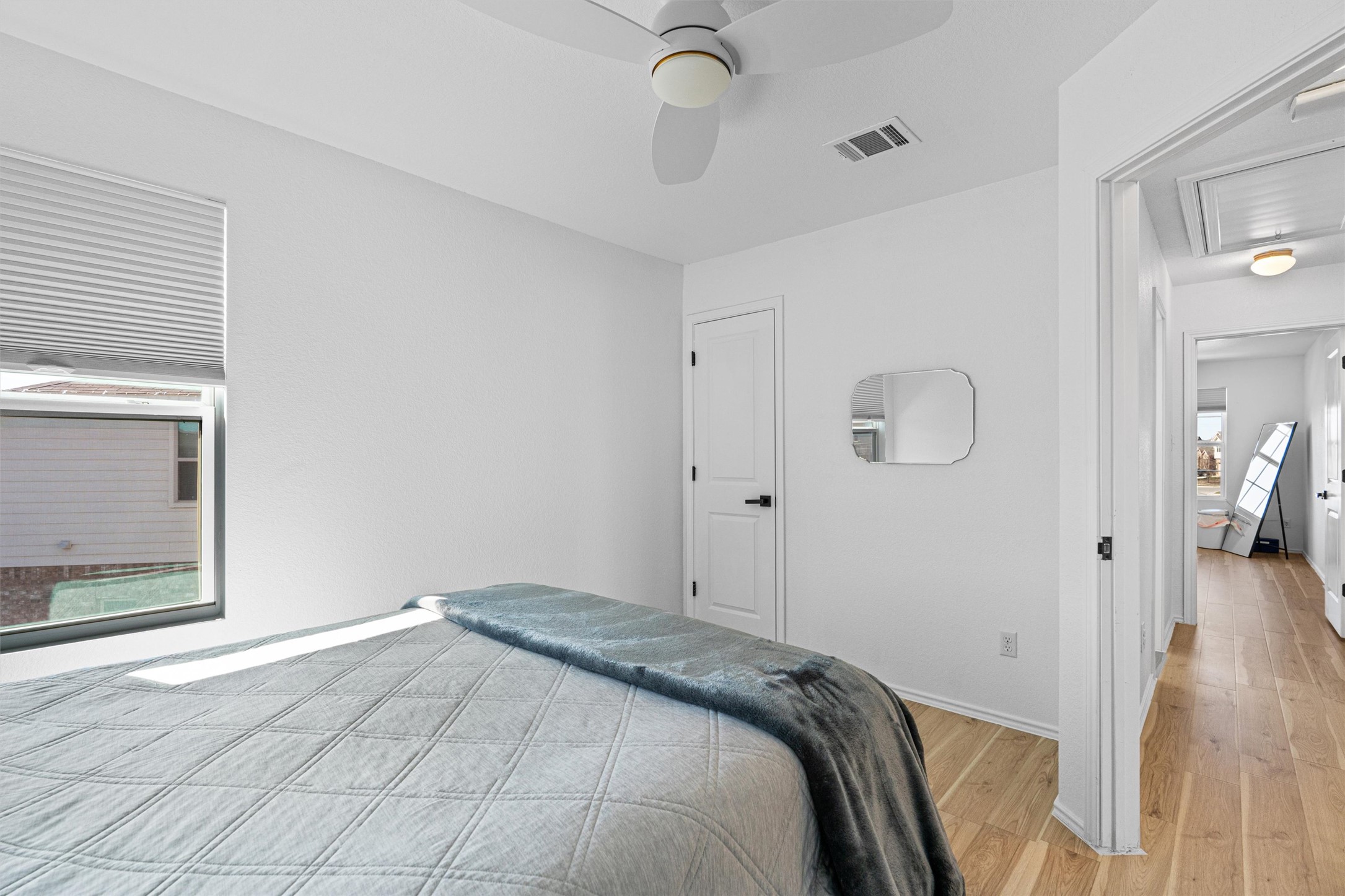 327 Andesite Trail Buda, TX 78610 - Photo 30 of 40 a bedroom with a bed and wooden floor