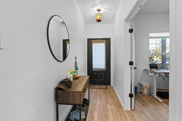 a living room with furniture and a wooden floor