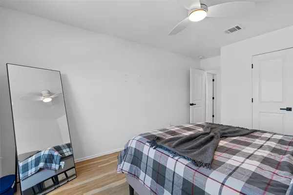 a bedroom with a bed and a mirror