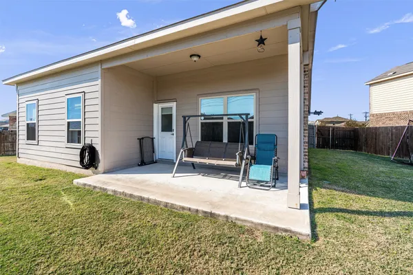 a view of a house with backyard and porch