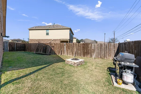 a view of a backyard with chairs