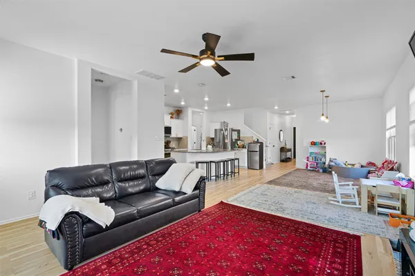 a living room with furniture and kitchen view