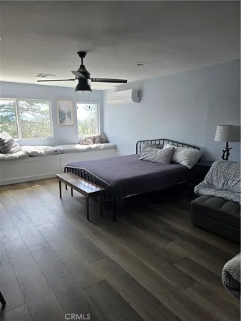 a room with a bed and a dresser