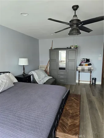 a bed sitting in a room next to a lamp