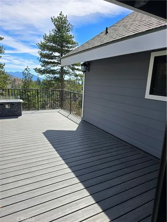 a view of a hallway with wooden floor and furniture