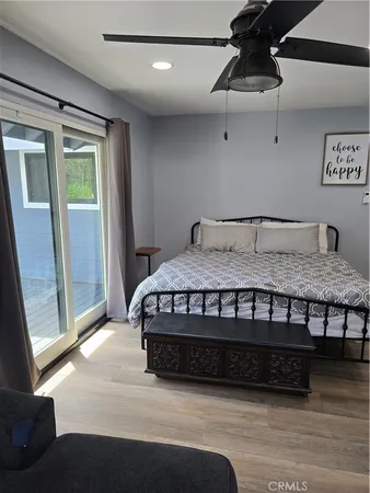 a dining room with furniture and a floor to ceiling window